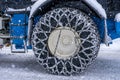 Closeup of a chained wheel of a snowy snow plow on the mountain ski resort in french Alps Royalty Free Stock Photo