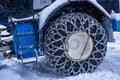 Closeup of a chained wheel of a snowy snow plow on the mountain ski resort in french Alps Royalty Free Stock Photo