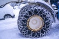 Closeup of a chained wheel of a snowy snow plow on the mountain ski resort in french Alps Royalty Free Stock Photo