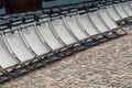 chairs alignment at open air cinema on cobbestone place Royalty Free Stock Photo