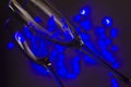 Closeup of champagne glasses against blurred garland lights.Concept of Christmas and New Year party Royalty Free Stock Photo