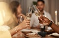 Closeup, champagne and glasses for celebration, party or friends enjoy New Years dinner or drinks together. Hands, toast
