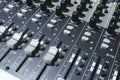 Closeup of a 16 channel digital stereo mixer - Focus on Channel faders and Aux knobs. Small recording studio setup Royalty Free Stock Photo