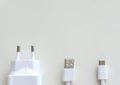 Closeup of a charger and a USB type C charging cable isolated on a gray background Royalty Free Stock Photo