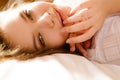 Closeup of charming woman lying on pillow in