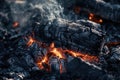 Closeup of Charred Burning Logs in a Dying Fire Outside on Ashcovered Ground Royalty Free Stock Photo