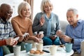 Closeup of cheerful elderly people chilling together, playing cards Royalty Free Stock Photo