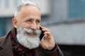 Closeup of cheerful senior man talking on phone Royalty Free Stock Photo