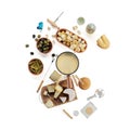 Closeup of a cheese platter, fondue, alcohol bottles, pickles and olives on a white background