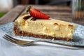 Closeup cheesecake with strawberry, fork and napkin on plate Royalty Free Stock Photo