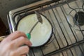 Closeup of a chef cooking tortillas in a pan on a stove