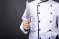 Closeup of a chef holding a big sharp knife