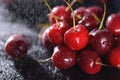 Closeup cherry with drops on black background