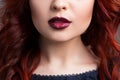 Closeup cherry lips. girl with red hair. the lower