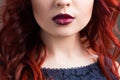 Closeup cherry lips. girl with red hair. the lower