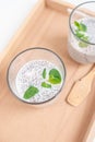 Closeup of chia seed pudding with mint on a wooden board