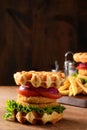 Closeup chicken burger waffle sandwich on wood table