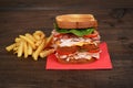 Closeup chicken club sandwich with fries