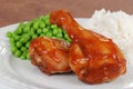 Closeup chicken leg with barbecue sauce and peas