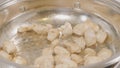 Closeup of chicken meat strips cooking on a hot pan on a gas stove. Chicken frying in a pan, Top view. Cooking fried Royalty Free Stock Photo