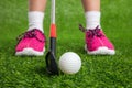 Closeup of a child golfer with putter and ball Royalty Free Stock Photo