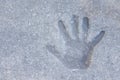 Closeup of a child's hand print in a concrete sidewalk mud sand Royalty Free Stock Photo