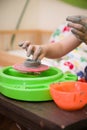 Closeup of child`s hands with potter`s wheel. Kid boy making a bowl of clay at pottery school Royalty Free Stock Photo