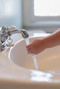 Closeup of child`s hands under running water