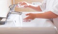 Closeup of a child`s soapy hands being washed under running water in a sink Royalty Free Stock Photo