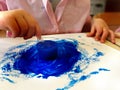 Closeup of children hands painting during a school activity - ice painting - learning by doing, education and art, art therapy