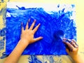 Closeup of children hands painting during a school activity - ice painting - learning by doing, education and art, art therapy Royalty Free Stock Photo