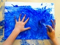 Closeup of children hands painting during a school activity - ice painting - learning by doing, education and art, art therapy Royalty Free Stock Photo