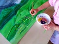 Closeup of children hands painting during a school activity - learning by doing, education and art, art therapy concept Royalty Free Stock Photo