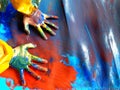 Closeup of children hands painting during a school activity - learning by doing, education and art, art therapy concept