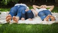 Closeup of children and mothers feet lying on grass in park or garden. Parenting, family, children development, and fun Royalty Free Stock Photo