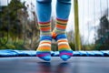 closeup of childs feet in colorful socks on trampoline mesh Royalty Free Stock Photo