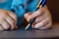 closeup of a childs hand writing with a fountain pen Royalty Free Stock Photo