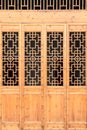 Closeup Chinese old wooden frame door with decorative pattern under the sunshine