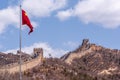 Closeup of Chinese red flag over Great Wall of China Royalty Free Stock Photo