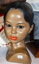 Closeup of chipped painted Hawaiian girl with painted eyes and grey in her hair at rummage sale wih price tag