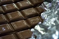 closeup of chocolate bars being wrapped in foil by machine Royalty Free Stock Photo