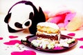 Closeup chocolate cake in plate on white table decoration heart and cute soft panda toy