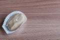 Closeup of chocolate eclair on wooden table Royalty Free Stock Photo