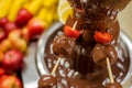 closeup of a chocolate fountain with fruits on skewers Royalty Free Stock Photo