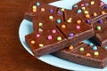 Closeup chocolate fudge brownies with candy pieces on blue plate Royalty Free Stock Photo