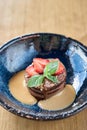 Closeup chocolate sponge cake, with caramel, decorated with strawberries and mint leaf. Breakfast in the cafe, morning Royalty Free Stock Photo