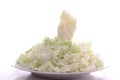 closeup, chopped chicory on a white plate on a plain white light background,