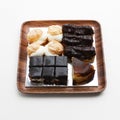 Closeup of choux pastry buns, cheesecake and eclairs on a wooden plate Royalty Free Stock Photo