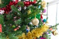 Closeup of Christmas baubles as golden glass ball and little clorolful gifts boxes that was decorated on Christmas tree branches Royalty Free Stock Photo