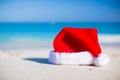 Closeup christmas hat on a white sandy beach Royalty Free Stock Photo